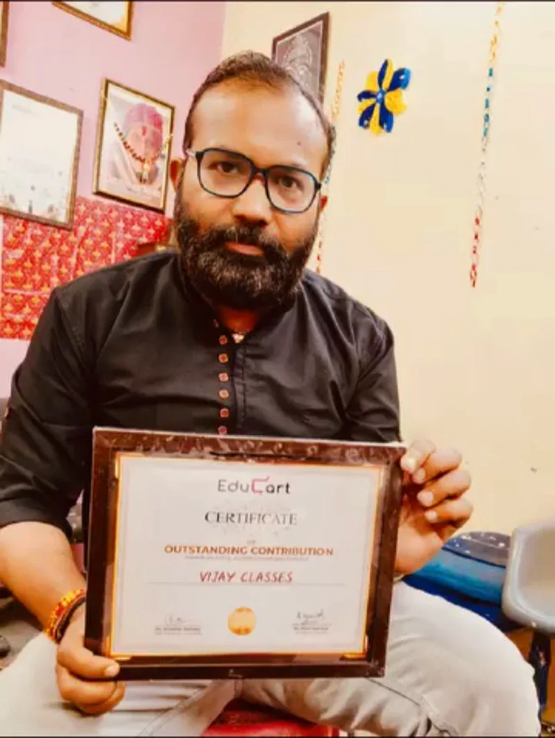Vijay Kishor Tiwari holding the EduCart Certificate of Outstanding Contribution awarded to Vijay Classes