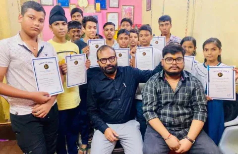 Vijay Classes students holding their certificates of merit, with Vijay sir seated in front
