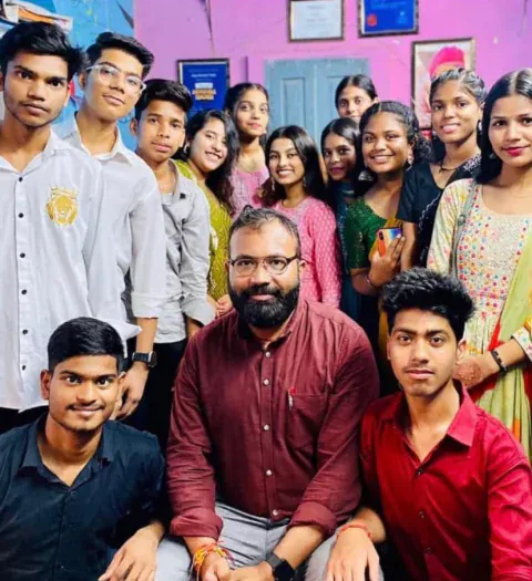 Vijay Kishor Tiwari with a group of smiling students at the centre