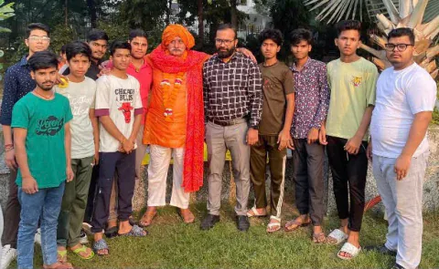 Vijay Kishor Tiwari and his students with an elder guest in a saffron turban and scarf, outdoors